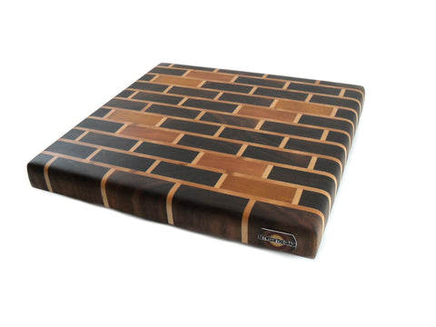 medium walnut brick end grain cutting board with yellow heart and cherry accents. 