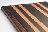 close up of walnut cutting board with 4 maple lines and juice groove