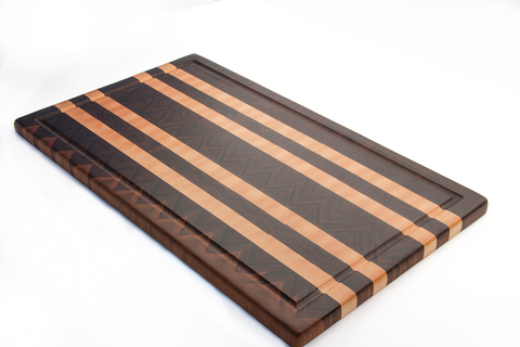 large walnut end grain cutting board with 4 maple lines running lengthwise