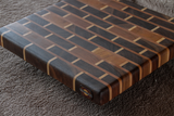 walnut brick pattern cutting board on soft grey background