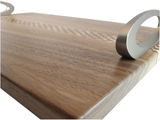close up of walnut serving tray with satin nickel handles and checker stripe running length wise.